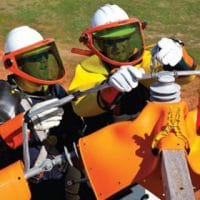 دو تکنسین با لباس محافظ در حال تست خطوط برق فشار قوی و تجهیزات عایقی